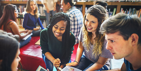 Young women smiling in group of people.