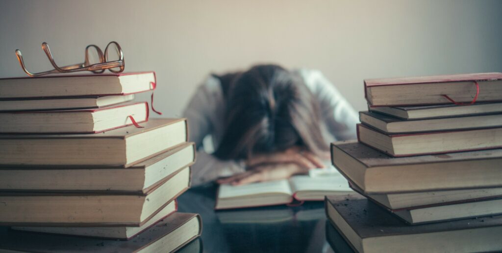 Student Studying Sleeping on Books