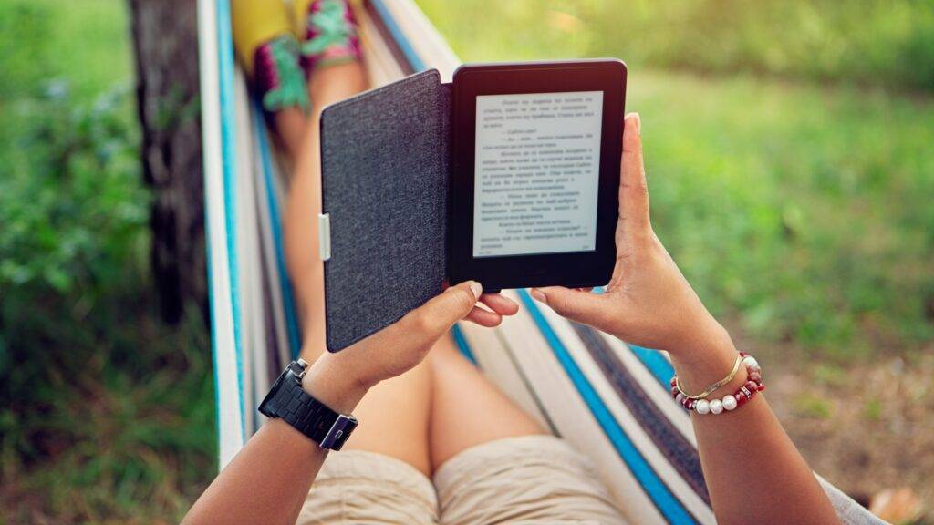 woman in a hammock reading an e-reader