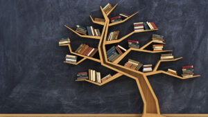 Book case in the shape of tree with books stacked on it