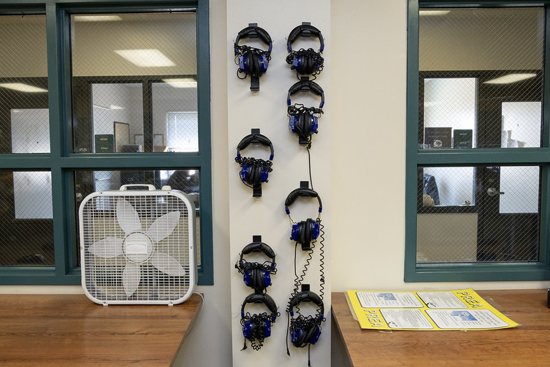 54623062694_942ab6eb43_c Headsets hanging on a wall in a prison library