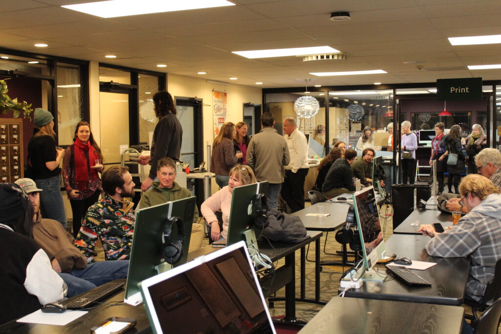 Community members mingle in the library's computer room. 