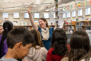 Flan smiles while instructing a class on how to complete the Francophonie Day activity.