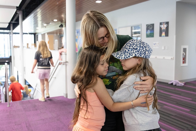 Ms. Steele hugs two of her students after their last class at the Curiosity Center together.